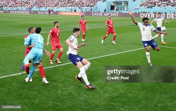 Iran's Alireza Beiranvand collides with team mate Majid Hosseini during the FIFA World Cup Qatar 2022 Group B match between England and IR Iran at...