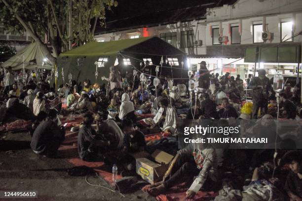 Wounded survivors of an earthquake are being treated in the yard of a hospital in Cianjur on November 21, 2022. - At least 56 people were killed in...