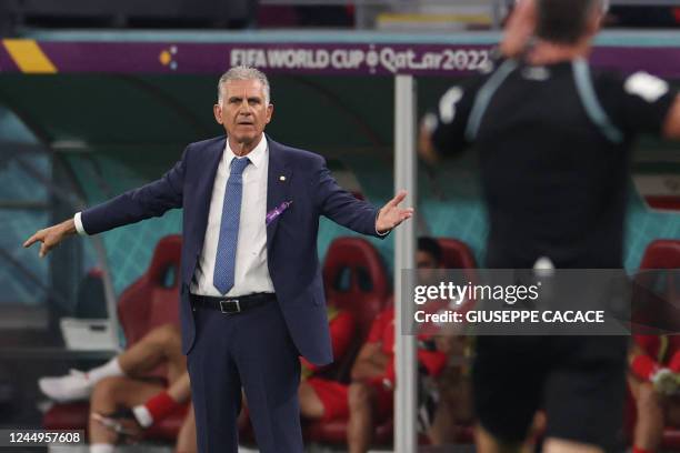 Iran's Portuguese coach Carlos Queiroz shouts instructions to his players from the touchline during the Qatar 2022 World Cup Group B football match...