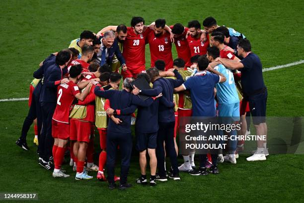 Iranian players gather with Iran's Portuguese coach Carlos Queiroz after the Qatar 2022 World Cup Group B football match between England and Iran at...