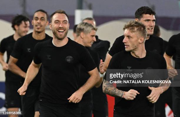 Denmark's midfielder Christian Eriksen and Denmark's defender Daniel Wass take part in a training session at the al Sailiya SC Training Site in Doha...
