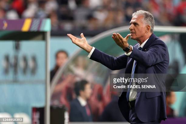 Iran's Portuguese coach Carlos Queiroz shouts instructions to his players from the touchline during the Qatar 2022 World Cup Group B football match...