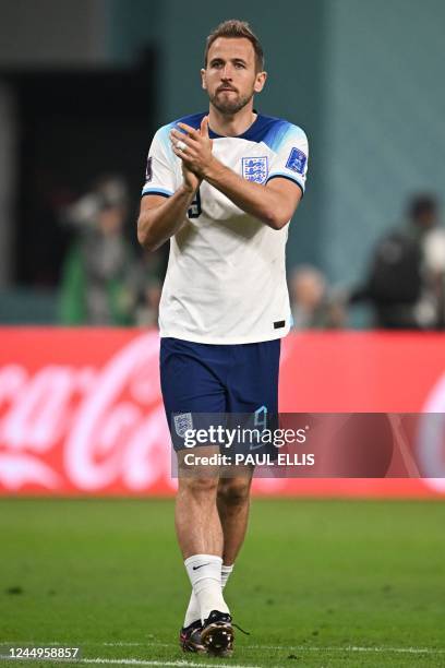 England's forward Harry Kane celebrates his team's win at the end of the Qatar 2022 World Cup Group B football match between England and Iran at the...