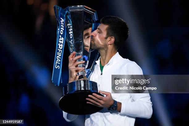 Novak Djokovic of Serbia kisses the trophy after the final match against Casper Ruud of Norway during day eight of the Nitto ATP Finals. Novak...