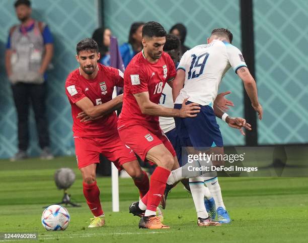 Ali Karimi of Iran and Mason Mount of England battle for the ball during the FIFA World Cup Qatar 2022 Group B match between England and IR Iran at...