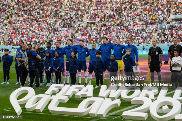 England team line up for the national anthem during the FIFA World Cup Qatar 2022 Group B match between England and IR Iran at Khalifa International...