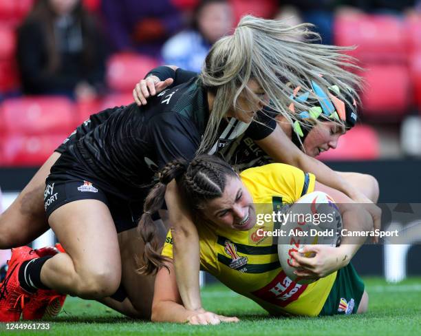 Australia's Jessica Sergis is tackled by New Zealand's Apii Nicholls during Women's Rugby League World Cup Final match between Australia and New...