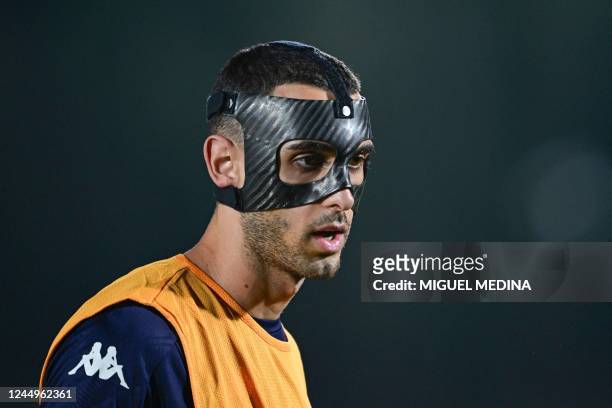 Tunisia's midfielder Ellyes Skhiri takes part in a training session wearing a protective face mask, at Al Egla facility in Doha on November 21 on the...