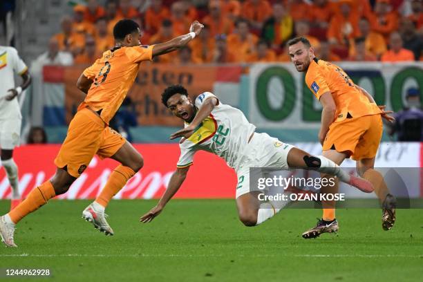 Senegal's defender Abdou Diallo fights for the ball with Netherlands' forward Luuk De Jong and Netherlands' forward Vincent Janssen during the Qatar...