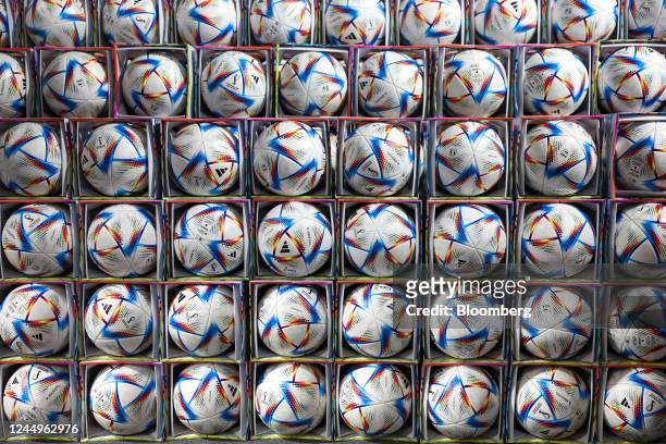 Racks of Adidas Ag 'Al Rihla' tournament matchballs inside an official FIFA store at the FIFA Fan Festival in Doha, Qatar, on Monday, Nov. 21, 2022....