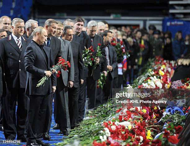 Prime Minister of Russia Vladimir Putin and president of the Russian Hockey Federation Vladislav Tretyak lay flowers for players, coaches and...