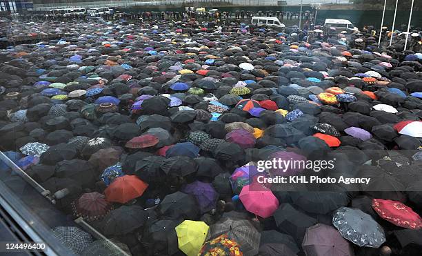 Mourners attend the ceremony for players, coaches and employees of the HC Lokomotiv Yaroslavl on September 10, 2011 at the Arena Yaroslavl in...