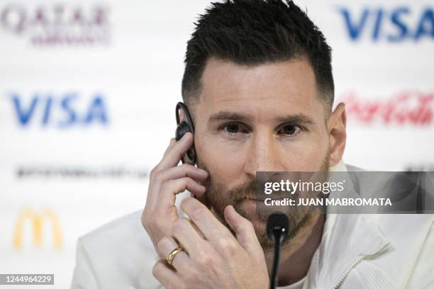 Argentina's forward Lionel Messi reacts as he gives a press conference at the Qatar National Convention Center in Doha, on November 21 on the eve of...