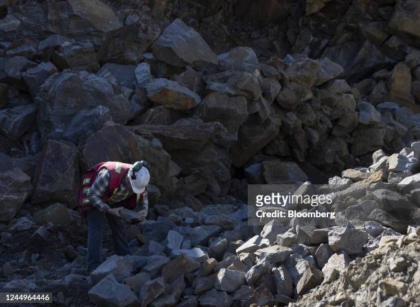 Worker inspects graphite ore at the Nouveau Monde Graphite Matawinie Mine in Saint-Michel-des-Saints, Quebec, Canada, on Thursday, Oct. 6, 2022....