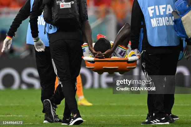 Senegal's midfielder Cheikhou Kouyate leaves the pitch on a stretcher after he sustained an injury during the Qatar 2022 World Cup Group A football...
