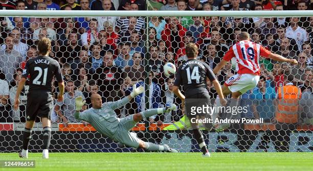 Pepe Reina of Liverpool fails to save a penilty shot from Jonathan Walters of Stoke City during the Barclays Premier League match between Stoke City...