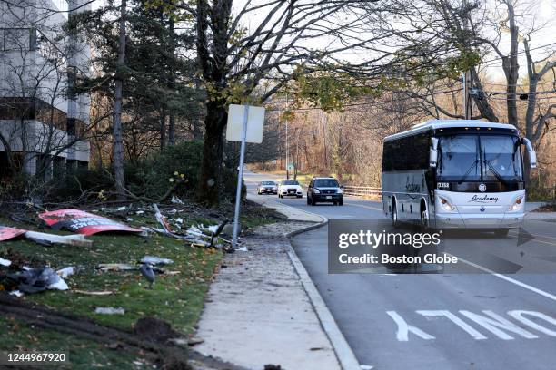 Waltham, MA A bus passes by the scene of a Brandeis University shuttle bus crash on South Street that left one person dead and 27 injured.
