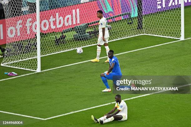 Senegal's goalkeeper Edouard Mendy and Senegal's defender Pape Abdou Cisse react after Netherlands' second goal during the Qatar 2022 World Cup Group...