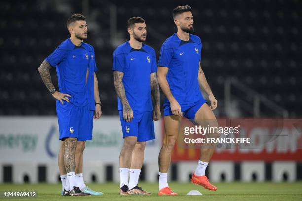 France's defender Lucas Hernandez, France's defender Theo Hernandez and France's forward Olivier Giroud take part in a training session in Doha, on...