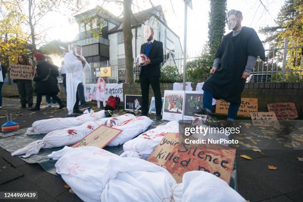 Dozen Iran activists gather and some with face masks of Sheikh of Qatar , and Iran Supreme Leader Ali Khamenei and FiFA president Gianni Infantino...