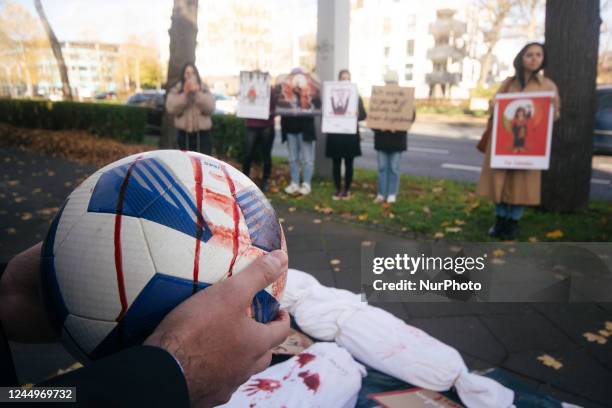 A football with artificial blood is seen during the boycott of Qatar 2022 protest in front of embassy of Qatar in Bonn, Germany on Nov 21, 2022