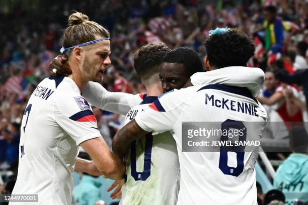 S forward Timothy Weah celebrates with teammates Walker Zimmerman, #10 Christian Pulisic and Weston McKennie after scoring his team's first goal...