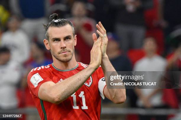 Wales' forward Gareth Bale greets the supporters at the end of the Qatar 2022 World Cup Group B football match between USA and Wales at the Ahmad Bin...