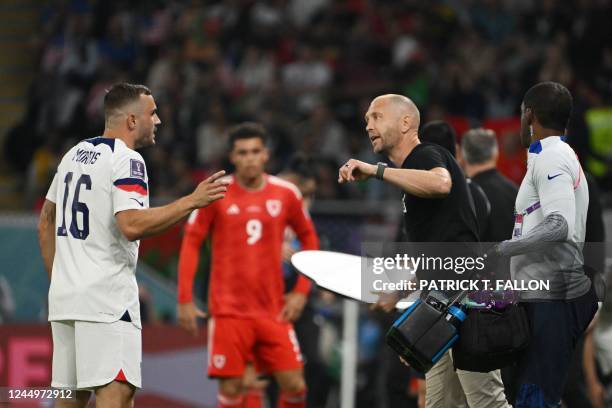 S forward Jordan Morris tales to USA's coach Gregg Berhalter during the Qatar 2022 World Cup Group B football match between USA and Wales at the...