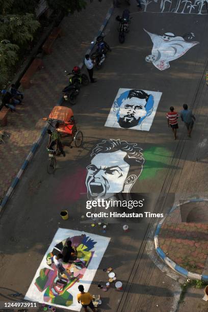Members of Patuli Sports Lover paint face of football players Messi, Ronaldo, Neymar on street with to celebrate Qatar World Cup 2022 on November 21,...