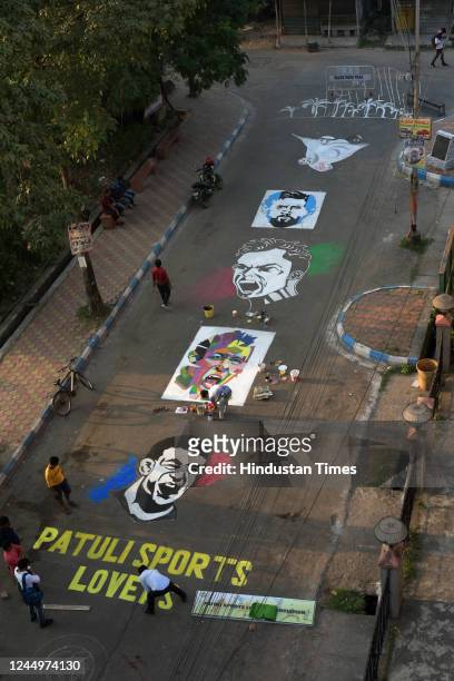Members of Patuli Sports Lover paint face of football players Messi, Ronaldo, Neymar and Mbappe on street with to celebrate Qatar World Cup 2022 on...