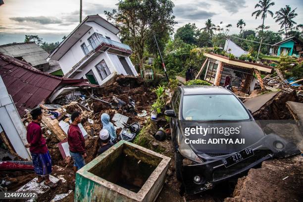 Villagers salvage items from damaged houses following a 5.6-magnitude earthquake that killed at least 162 people, with hundreds injured and others...