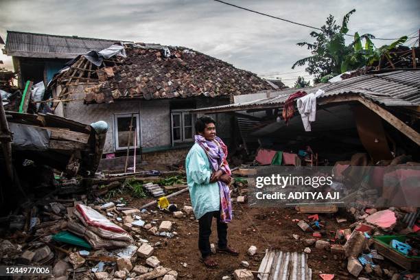 Villager looks at damaged houses following a 5.6-magnitude earthquake that killed at least 162 people, with hundreds injured and others missing in...