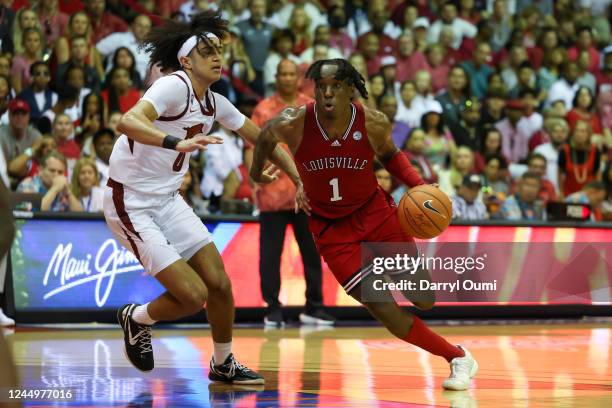 Mike James of the Louisville Cardinals attempts to get past Anthony Black of the Arkansas Razorbacks in the second half of the game during the Maui...