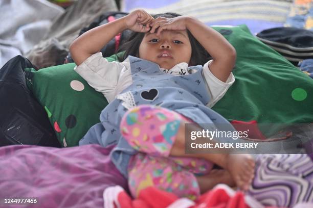 Girl rests at a temporary shelter following a 5.6-magnitude earthquake that killed at least 162 people, with hundreds injured and others missing in...