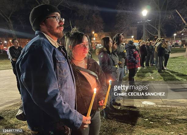 People hold candles during a vigil at Acacia Park for the victims of a mass shooting at Club Q, an LGBTQ nightclub, at Acacia Park in Colorado...
