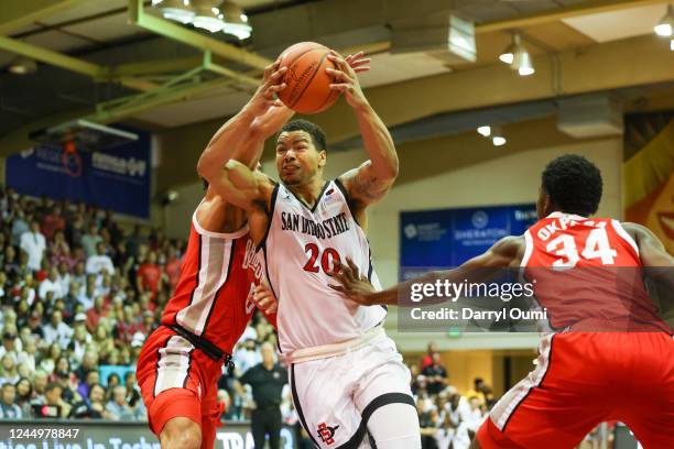 Matt Bradley of the San Diego State Aztecs drives to the basket between Tanner Holden and Felix Okpara of the Ohio State Buckeyes in the first half...