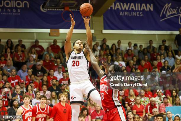 Matt Bradley of the San Diego State Aztecs takes a jump shot over Isaac Likekele of the Ohio State Buckeyes in the first half of the game during the...