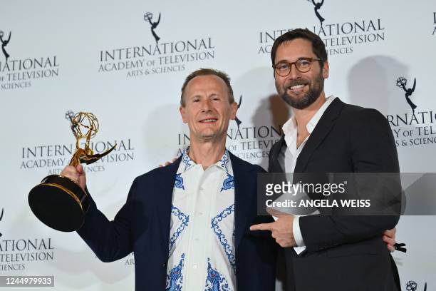 British film director Marc Munden poses next to US actor Ryan Eggold with his award for Best TV Movie/Mini-Series for "Help" during the 50th...