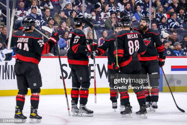 Seth Jarvis, Andrei Svechnikov, Sebastian Aho, Martin Necas and Brent Burns of the Carolina Hurricanes celebrate a third period goal against the...