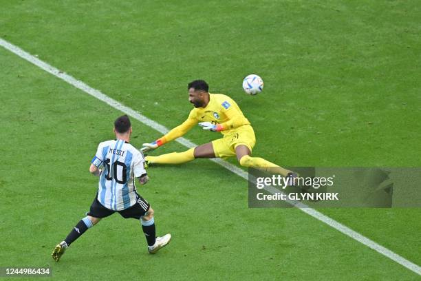 Argentina's forward Lionel Messi scores a goal past Saudi Arabia's goalkeeper Mohammed Al-Owais but it was disallowed for offside during the Qatar...