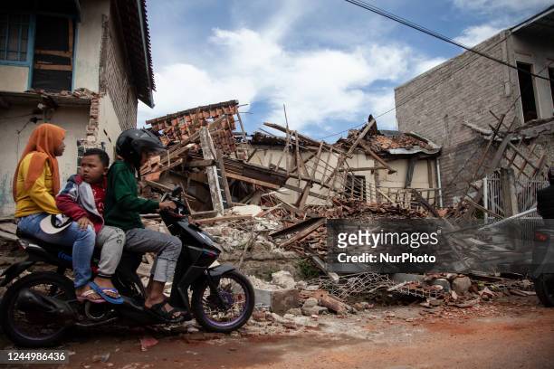 Residents of Gasol village, do their activities among the ruins of their village after the 5.6 earthquake shook a number of areas in Cianjur Regency,...