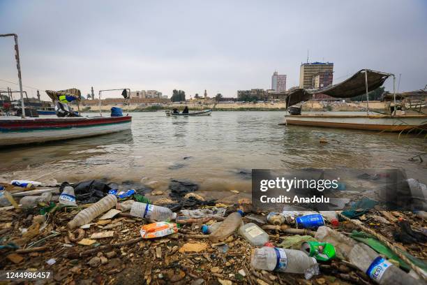 View of boats and trash on Tigris River, heavily polluted due to chemical waste and garbage dump in Baghdad, Iraq on November 16, 2022. As sewage...