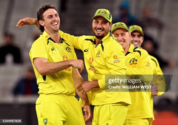 Australia's Mitch Marsh celebrates with teammate Marcus Stoinis after dismissing England's Liam Dawson during the third one-day international cricket...