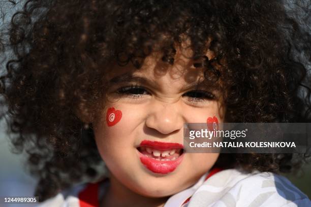 Young girl, fan of Tunisia, arrives at the Education City Stadium in Al-Rayyan, west of Doha, on November 22 for the Qatar 2022 World Cup Group D...