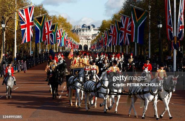 South Africa's President Cyril Ramaphosa rides with Britain's King Charles III and Britain's Camilla, Queen Consort in the Irish State Coach, as they...