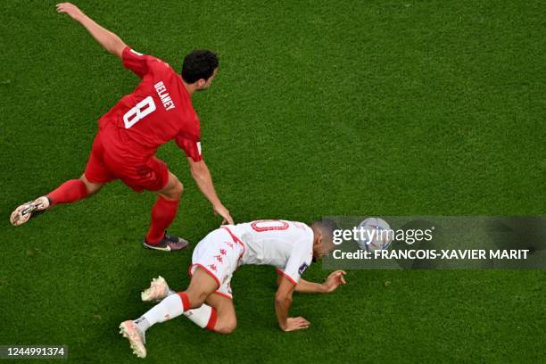 Denmark's midfielder Thomas Delaney fights for the ball with Tunisia's defender Mohamed Drager during the Qatar 2022 World Cup Group D football match...