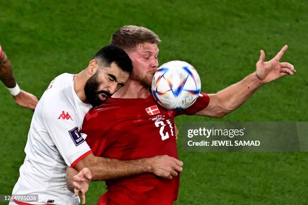 Tunisia's defender Yassine Meriah fights for the ball with Denmark's forward Andreas Cornelius during the Qatar 2022 World Cup Group D football match...