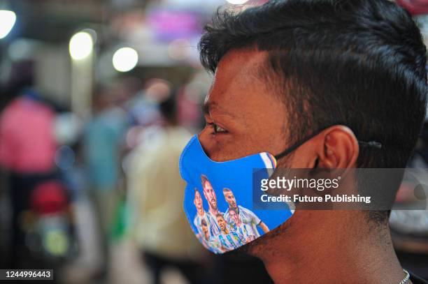 Fan wears a face mask with a graphic of the Argentinian football team at a market during the FIFA World Cup 2022. On November 22, 2022 in Sylhet,...