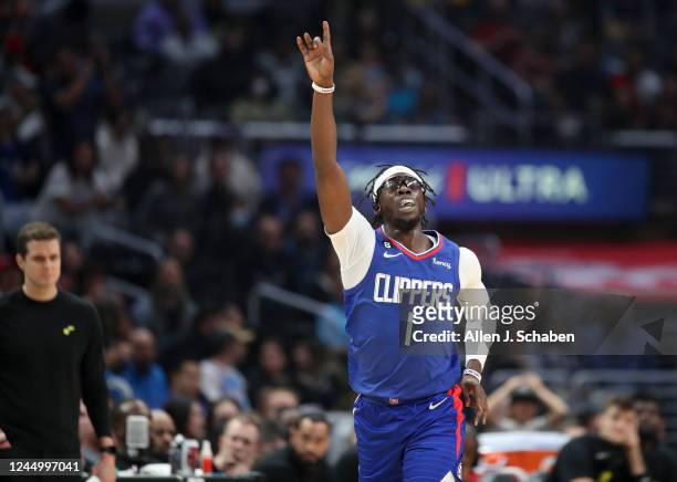 Los Angeles, CA Clippers guard Reggie Jackson celebrates a three-pointer against the Utah Jazz as Jazz coach Will Hardy watches in the first half at...