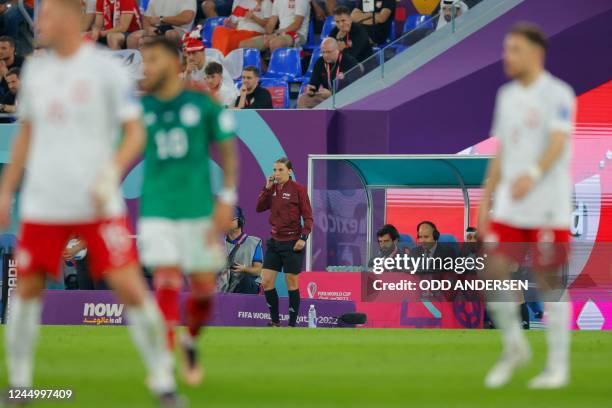 French referee Stephanie Frappart watches players from the touchline during the Qatar 2022 World Cup Group C football match between Mexico and Poland...